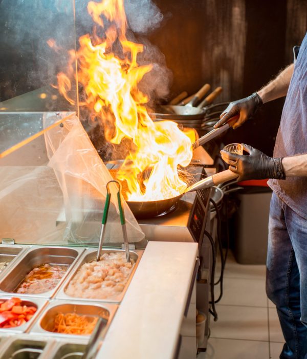 Chief cook cooking at the asian kitchen