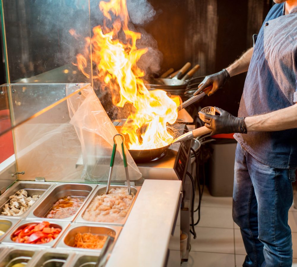 Chief cook cooking at the asian kitchen