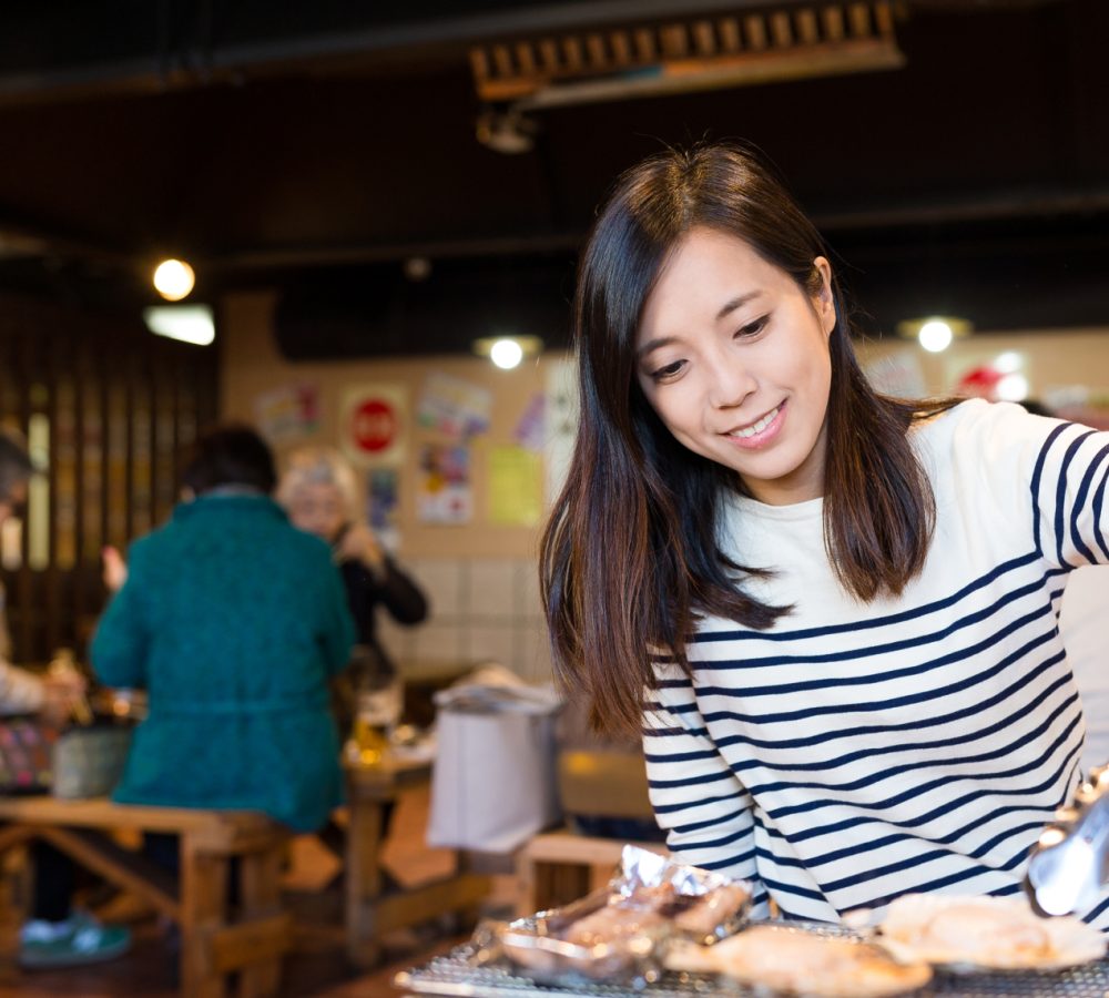 woman-having-grilled-seafood-in-japanese-restauran-2023-11-27-05-13-52-utc 1